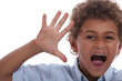 Foto: Little boy with raised hand Little boy with raised hand