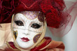 Person in Venetian costume attends Carnival of Venice.