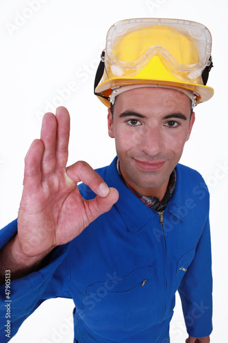 Photo: closeup portrait of craftsman making ok sign closeup portrait of craftsman making ok sign