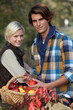 Photo: Young couple picking apples Young couple picking apples