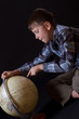 Boy looking at a globe