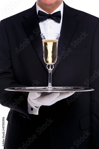 Photo: Butler serving a glass of champagne Butler serving a glass of champagne