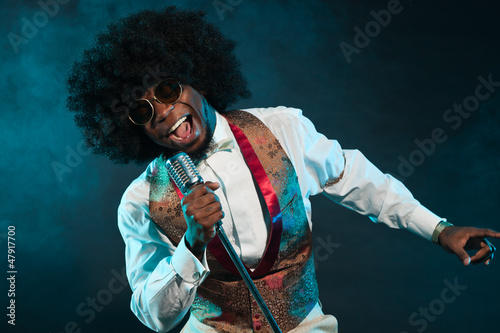 Photo: Black american disco soul singer. Vintage. Studio shot. Black american disco soul singer. Vintage. Studio shot.