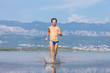 Man run across the beach