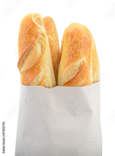 Photo: Baguette bread in paper bag isolated on white Baguette bread in paper bag isolated on white