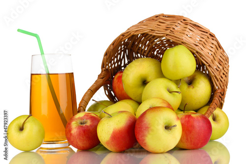 Photo: Useful apple juice with apples around in basket isolated Useful apple juice with apples around in basket isolated