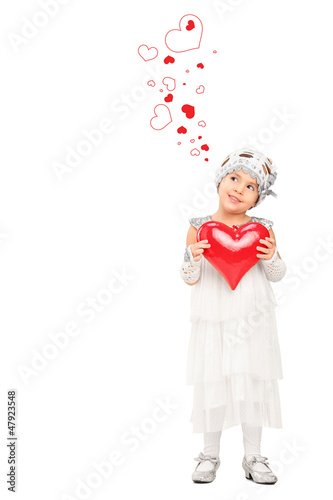 Photo: Full length portrait of a girl holding a red heart and looking a Full length portrait of a girl holding a red heart and looking a
