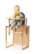 Baby sitting in highchair.