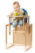 Baby sitting in highchair.