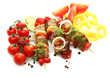 tasty grilled meat and vegetables on skewers, isolated on white