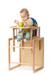 Baby sitting in highchair.