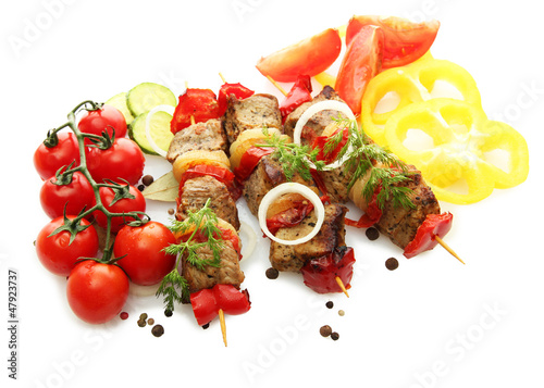 Photo: tasty grilled meat and vegetables on skewers, isolated on white tasty grilled meat and vegetables on skewers, isolated on white