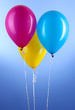Three colorful balloons on blue background