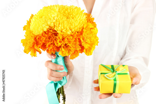 Photo: woman holds a box with a gift and flowers woman holds a box with a gift and flowers