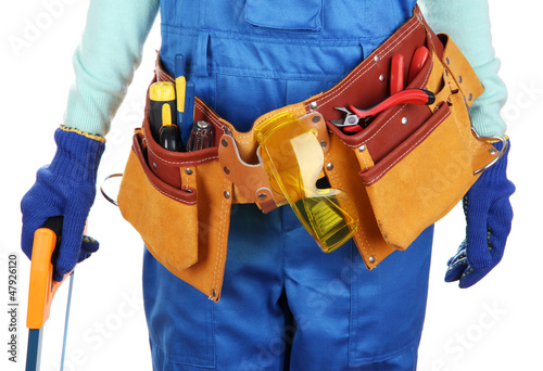 Photo: Male builder in blue overalls with saw isolated on white Male builder in blue overalls with saw isolated on white