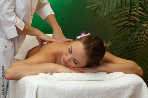Photo: beautiful young woman in spa salon getting massage, beautiful young woman in spa salon getting massage,