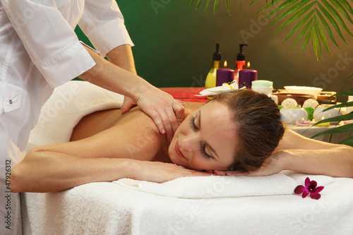 Photo: beautiful woman in spa salon with stones getting massage, beautiful woman in spa salon with stones getting massage,