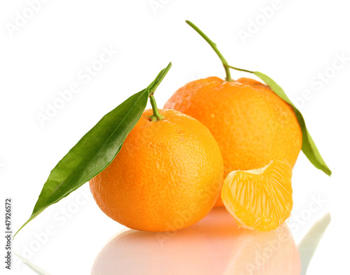 Photo: Ripe sweet tangerine with leaves, isolated on white Ripe sweet tangerine with leaves, isolated on white