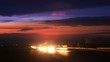 Cars quickly go on way on against sunset