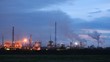 Chimney shaft of phosphoric factory stand against sky