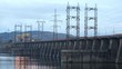 Cars go on bridge which is also spillway dike closeup