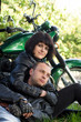 Couple of lovers sitting by motorcycle
