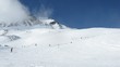 Skiers turn on slope of mountain Tiefenbachkogl