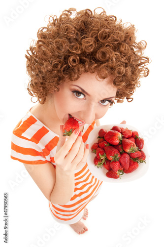 Photo: Fun woman with strawberry on the white background Fun woman with strawberry on the white background