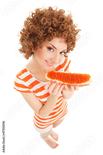 Photo: fun woman eating the sandwich with red caviar on the white backg fun woman eating the sandwich with red caviar on the white backg