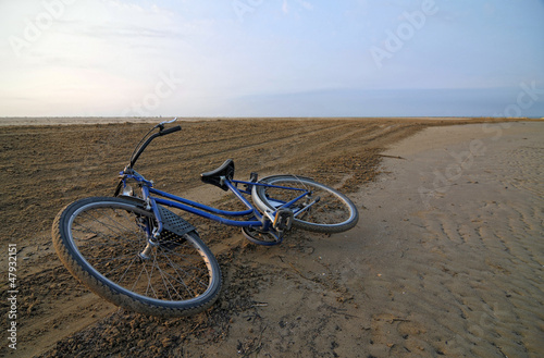 Photo: Abandoned bicycle along an empty beach Abandoned bicycle along an empty beach