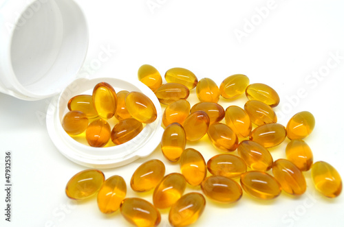 Photo: Rice oil pills isolated on white background Rice oil pills isolated on white background