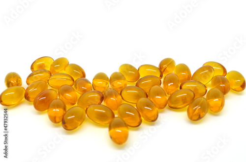 Photo: Pile of rice oil pills isolated on white background Pile of rice oil pills isolated on white background
