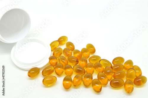 Photo: Rice oil pills isolated on white background Rice oil pills isolated on white background