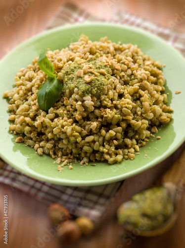 Photo: spelt with pesto sauce and hazel nut, selective focus spelt with pesto sauce and hazel nut, selective focus