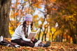 Foto : beautiful girl with book in the autumn park beautiful girl with book in the autumn park