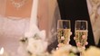 In two glasses champagne on wedding is poured