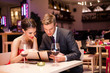  Smiling couple decide what to order