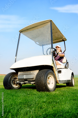 Photo: Woman in golf cart Woman in golf cart
