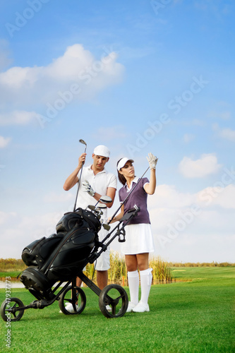 Photo: couple playing golf at the club couple playing golf at the club