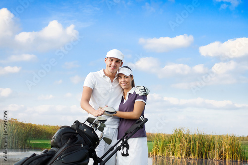 Photo: Golf couple with golf bag Golf couple with golf bag