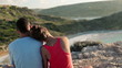 Video: Couple sitting and looking at beautiful landscape, crane shot Couple sitting and looking at beautiful landscape, crane shot