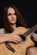 young teenage woman with an acoustic guitar