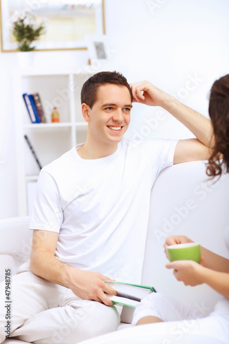 Photo: Young man at home with a book Young man at home with a book