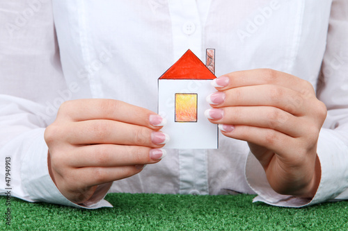 Photo: concept: woman hands with paper house, close up concept: woman hands with paper house, close up