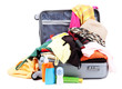 Open silver suitcase with clothing isolated on white