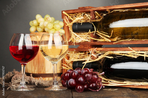 Photo: Wooden case with wine bottles, barrel, wineglasses and grape Wooden case with wine bottles, barrel, wineglasses and grape