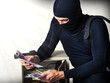 Professional burglar in black mask