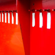 Red metal wall with bolts