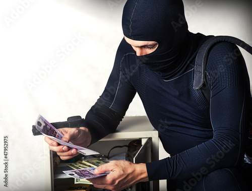 Photo: Professional burglar in black mask Professional burglar in black mask
