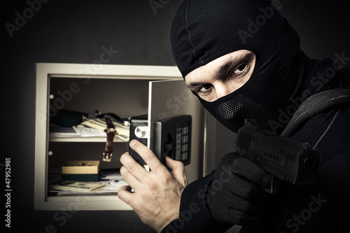 Photo: Professional burglar in black mask Professional burglar in black mask